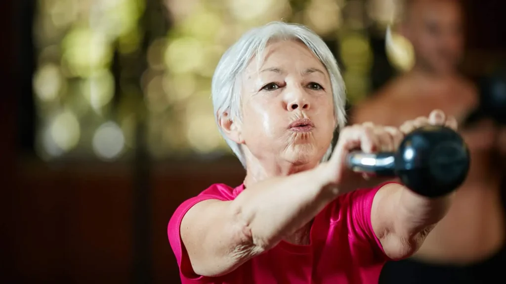Toning Arms Without the Bulk: Is It Achievable? 1 Woman doing resistance band exercises for toned arms Lutterworth
