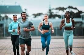 Sculpting Sleek Arms: The Essential Role of Cardio in Toning Without Bulking Up 3 image of people running to incorporate cardio Lutterworth exercise into their life to help tone arms and body.